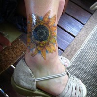 Designed sun-flower ankle tattoo