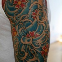 Flowers in waves arm tattoo