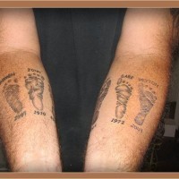 Tracks of feet arm tattoo