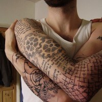 Wheels in labyrinth arm sleeve tattoo