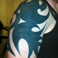 Black ornament arm tattoo