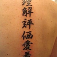 Scrittura asiatica tatuata sulla schiena