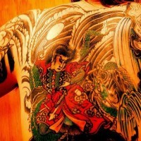 Fighting man on upper back asian   tattoo