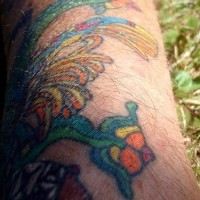 Coloured aztec style tattoo