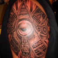 Sun stone with eye tattoo on shoulder