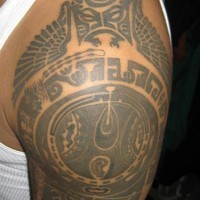 Tatuaje en el hombro en tracería azteca blanca y negra.