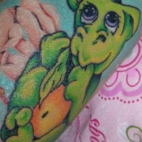 Green baby dragon tattoo