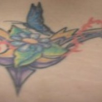 Hummingbird on flower tattoo in colour