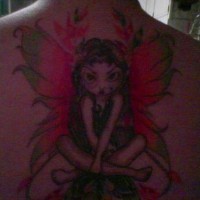 On upper back little and angry  fairy  tattoo