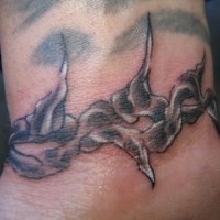 Realistic barb wire ankle tattoo