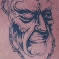 Ugly mask on barb wire tattoo
