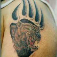 Angry bear in paw print tattoo