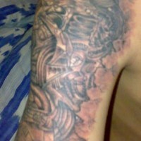 Biomechanical creature tattoo on shoulder