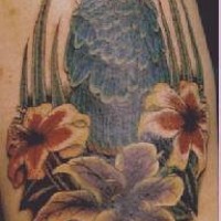 Blue macaw in flowers tattoo