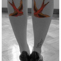 Two birds tattoo on both legs
