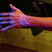 Arm bones glowing tattoo