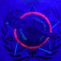 Guerilla logo glowing ink tattoo