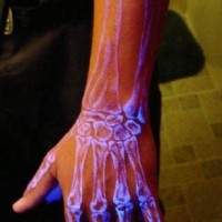 Arm bones glowing ink tattoo