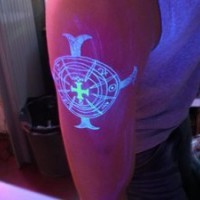 Glowing cross uv ink tattoo