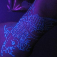 Koi fish glowing ink tattoo