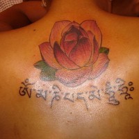 Lotus and buddhist mantra tattoo
