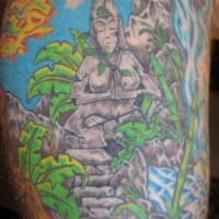 Stone buddha statue in forest coloured tattoo