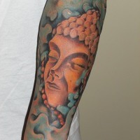 Stone buddha coloured sleeve tattoo