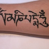 Hindu buddhist mantra tattoo on arm