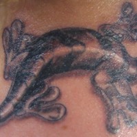 Bug eyed lizard tattoo on neck