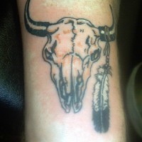 Bull skull with one feather tattoo