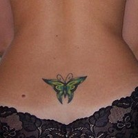 Green butterfly tattoo on tail base