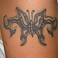 Schwarzer Tribal Schmetterling Tattoo am Arm