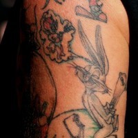 Tatuaje en el hombro del pájaro Tweety y Bugs Bunny.