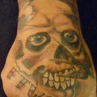 Skull with golden tooth tattoo