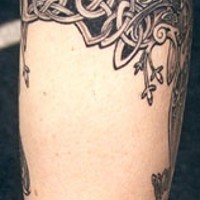 Celtic tracery tattoo on leg