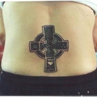Stone celtic cross lower back tattoo