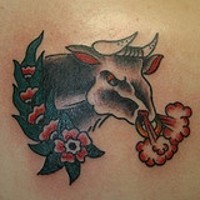 Angry bull in flowers tattoo in colour