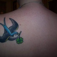 Sparrow with four leaf clover tattoo