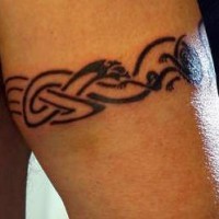Celtic tracery armband tattoo on arm