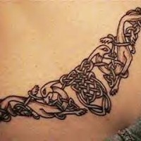 Lower back tattoo with celtic style wolves