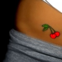 Bright red cherry tattoo