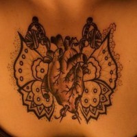 Organ as butterfly chest tattoo