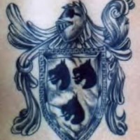 Black ink heraldic shield tattoo