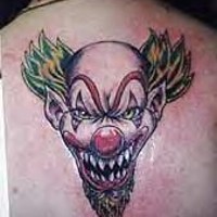 Evil sharp toothed clown tattoo on back