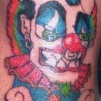 Colourful clown with piercing tattoo