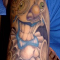 Crazy  colourful clown arm tattoo