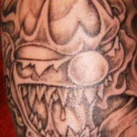 Evil sharp toothed clown tattoo