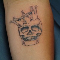 Crowned skull black ink tattoo