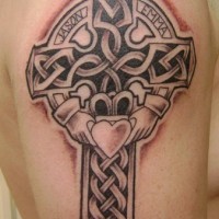 Celtic cross and heart in hands tattoo