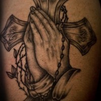 Cross and praying hands tattoo
